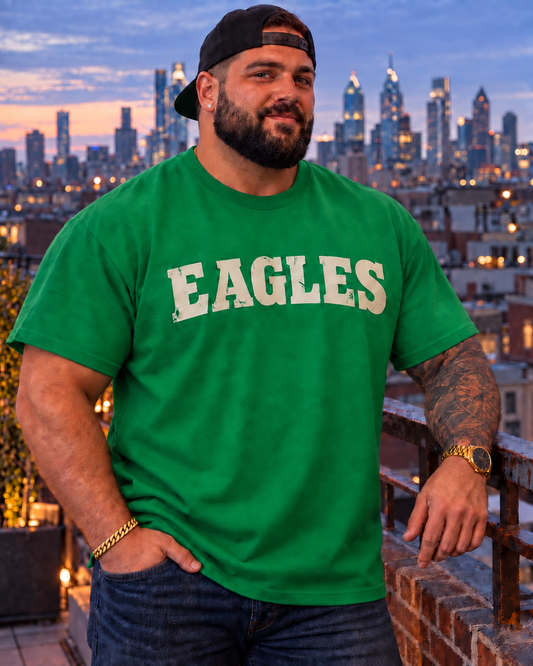 Man wearing a Kelly green Eagles T-shirt overlooking the Philadelphia skyline