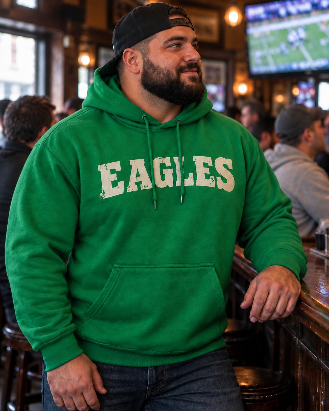 Model wearing a Kelly green Eagles hoodie with vintage cream wordmark
