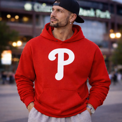 Man wearing a red hoodie with a white 'P' logo, standing outdoors.