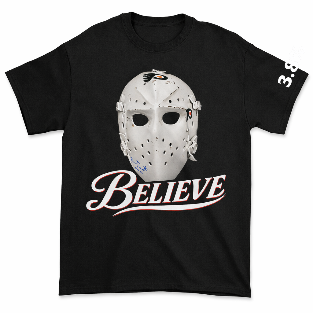 Black t-shirt with a hockey goalie mask graphic and 'BELIEVE' text on a white background