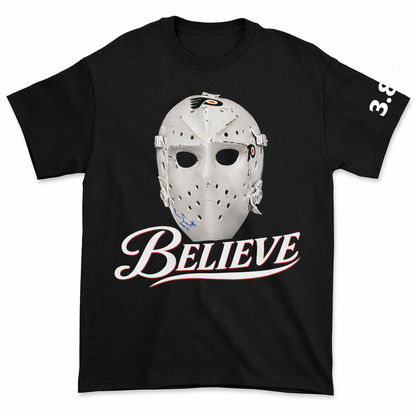 Black t-shirt with a hockey goalie mask graphic and 'BELIEVE' text on a white background